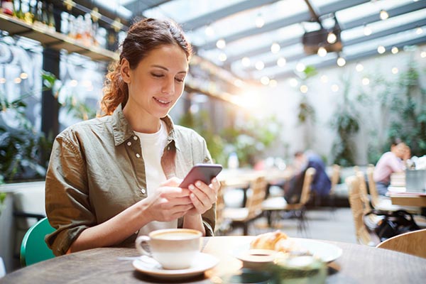 woman on phone at cafe